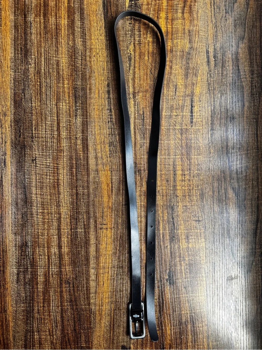 Brand new without tags (NWOT) classic solid black skinny belt with a silver-tone